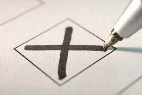 A pen marking an X vote in a box