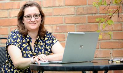 Image courtesy of Photo Credit: AlijPhotos Vicky Price seated at table with laptop